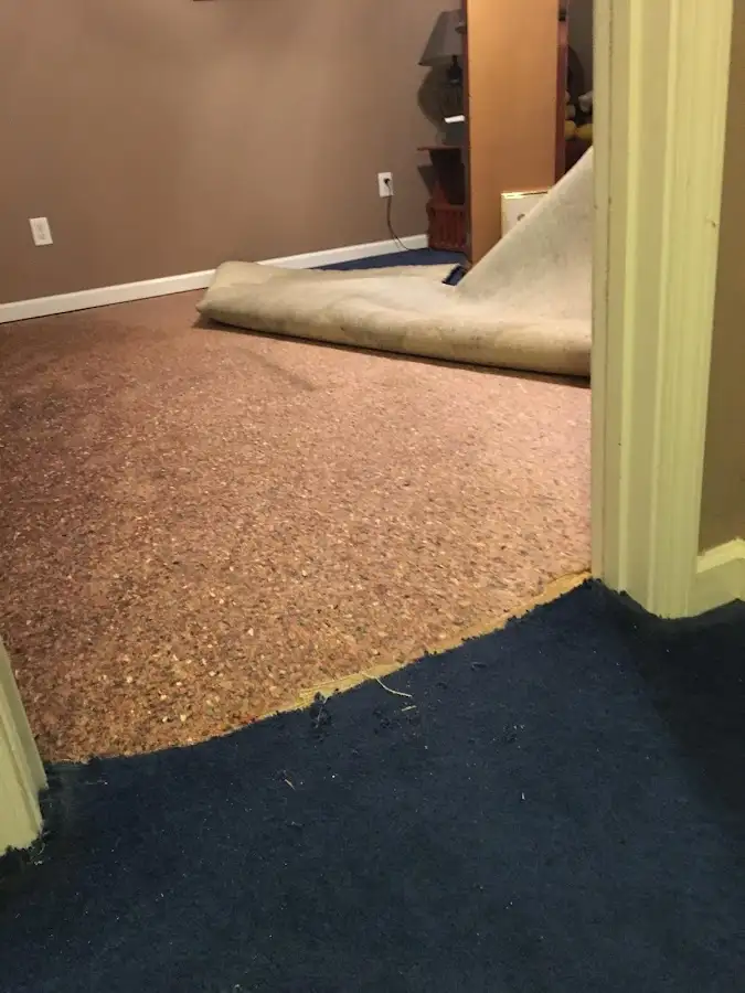 Carpet pad removal revealing water damage during Water Mitigation Services in Sacramento